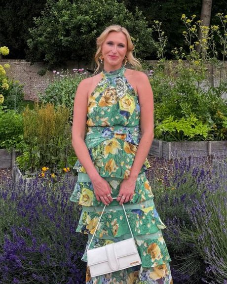 Maddy McEnery outdoors in a garden, wearing a green floral dress.